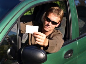 Military Members: Make Sure Your Drivers License is Valid man with driver license 300x225 Military Members: Make Sure Your Drivers License is Valid